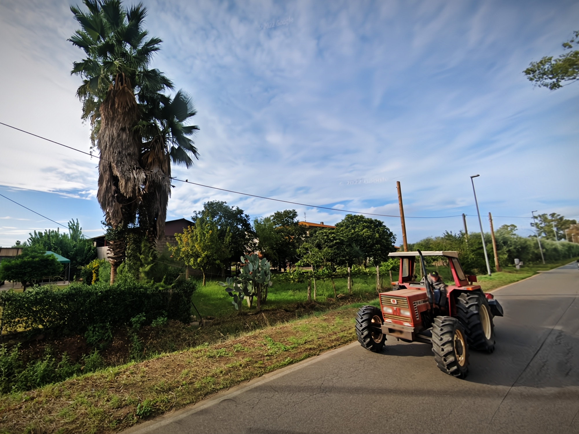 ​Google Street view screenshot of a tractor driving in Borgo Santa Maria, Latina