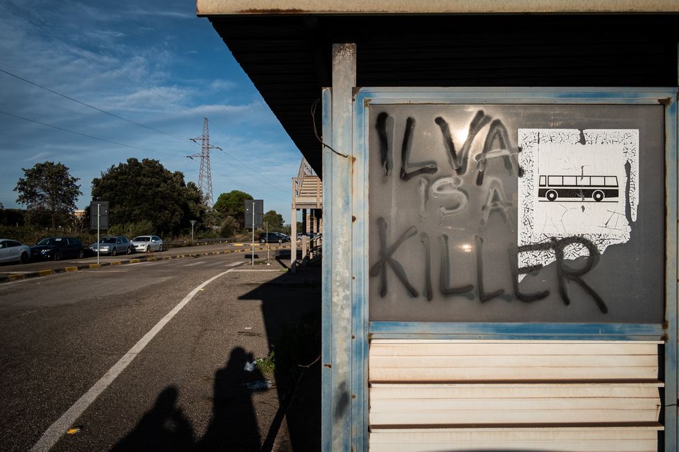 ​Graffati on a bus sign reading "Ilva is a killer"