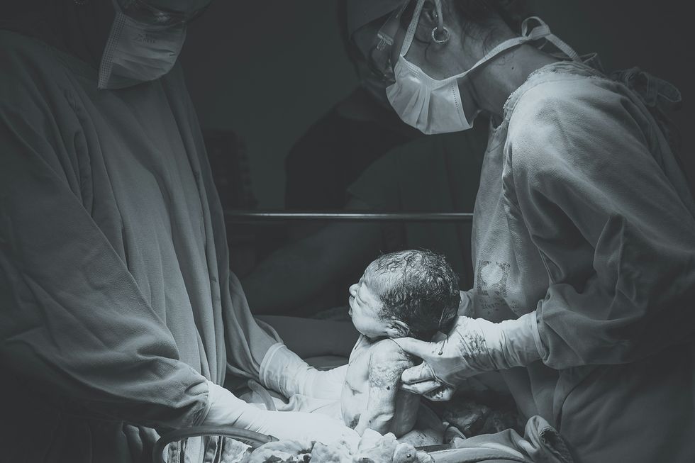 ​Grayscale photo of a medical operation.