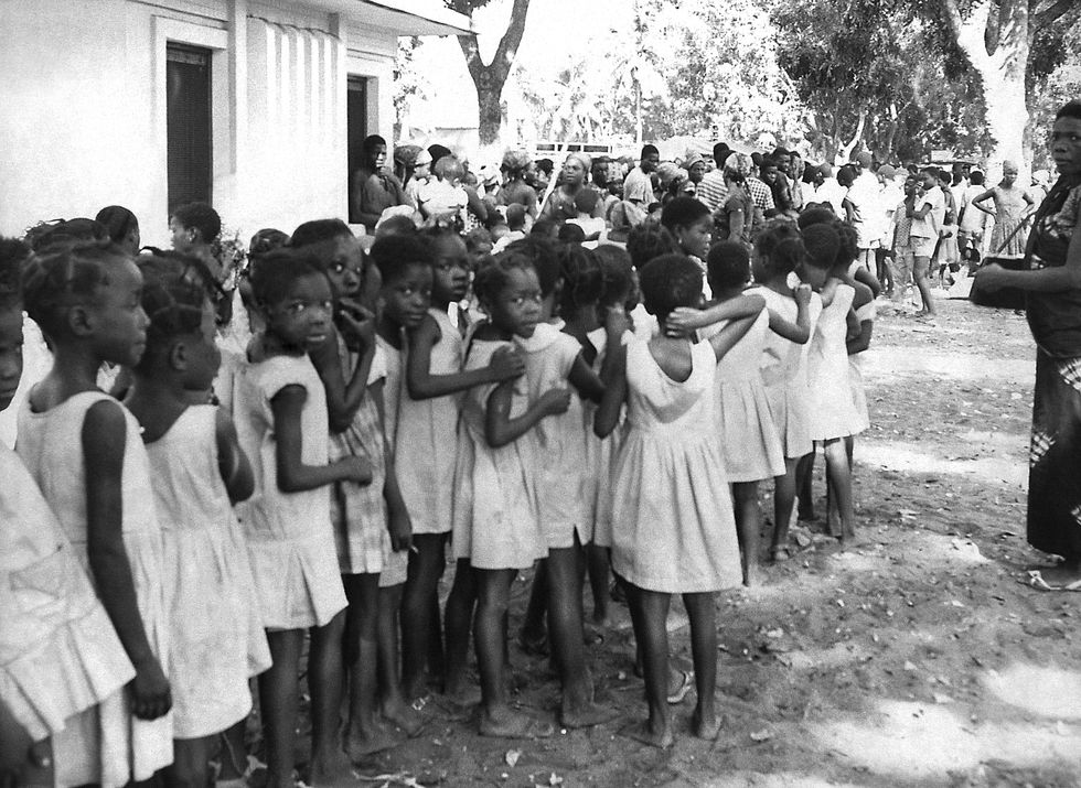 ​Group of local children waiting to receive a smallpox inoculation in Contonou, Benin.