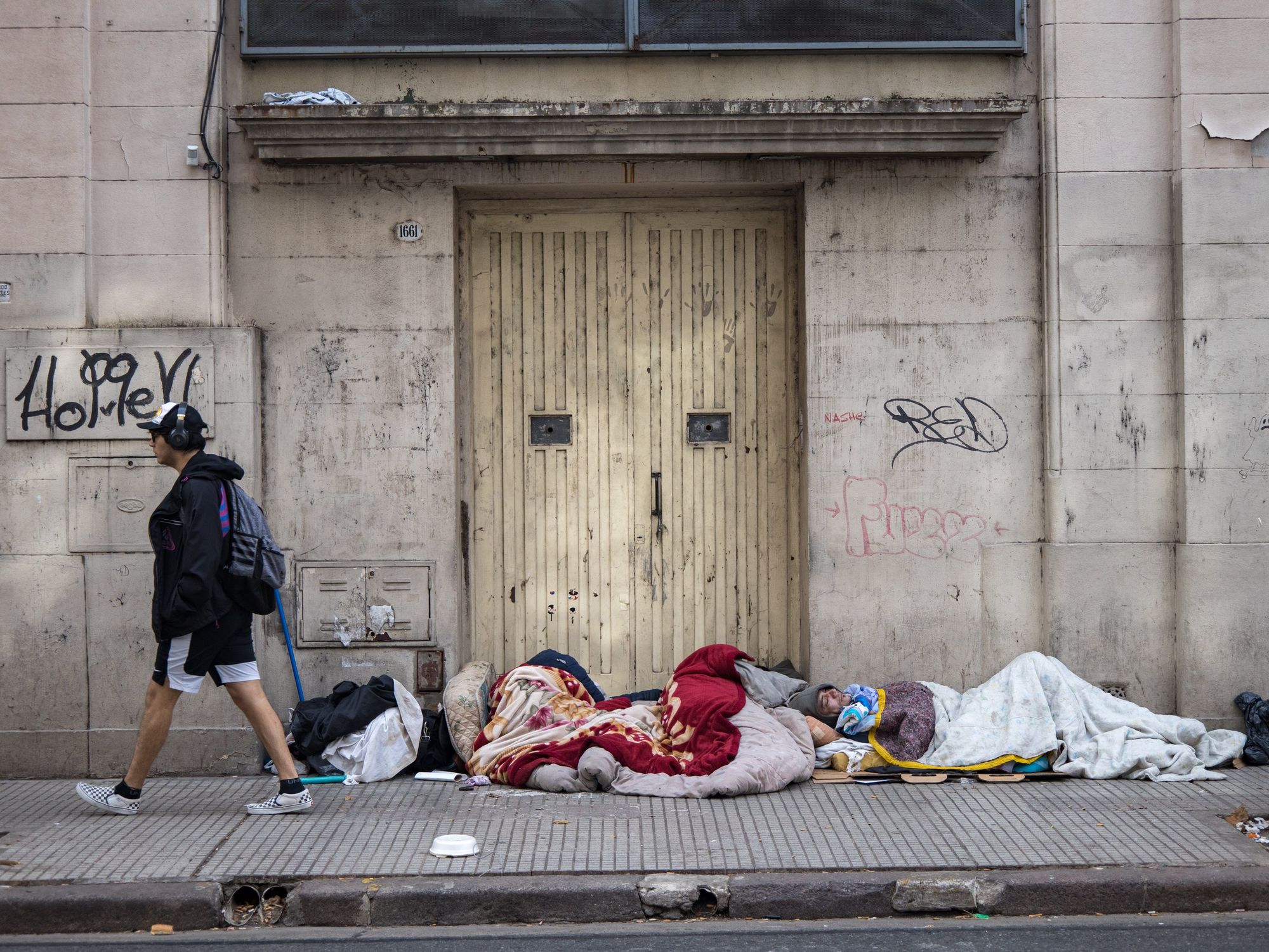 ​Homeless people sleep in front of the entrance to a building, Argentina, Buenos Aires, June 4, 2024.