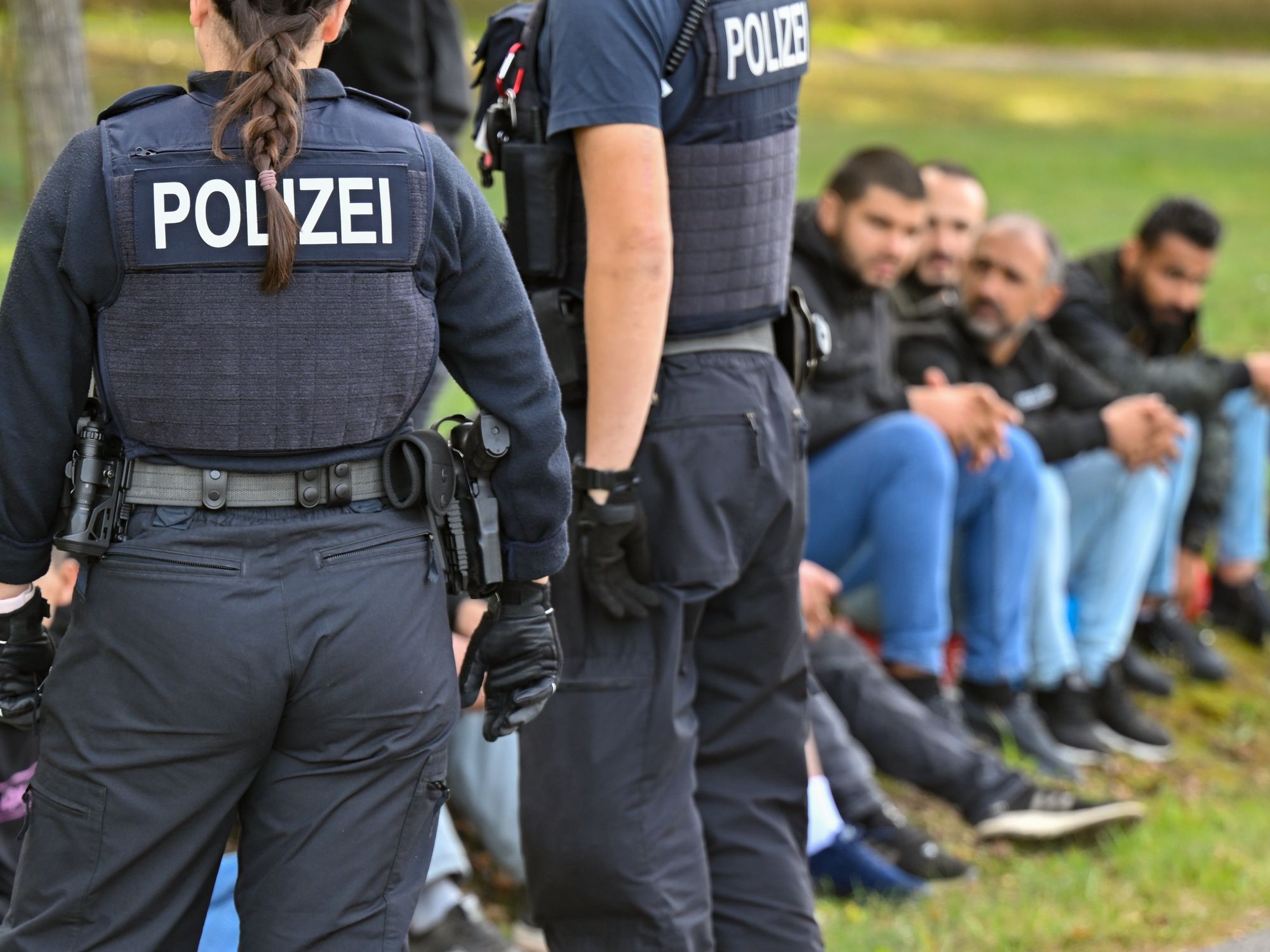 ​Illegal migrants are guarded by officers of the Federal Police near the German-Polish border in Forst (Lausitz).