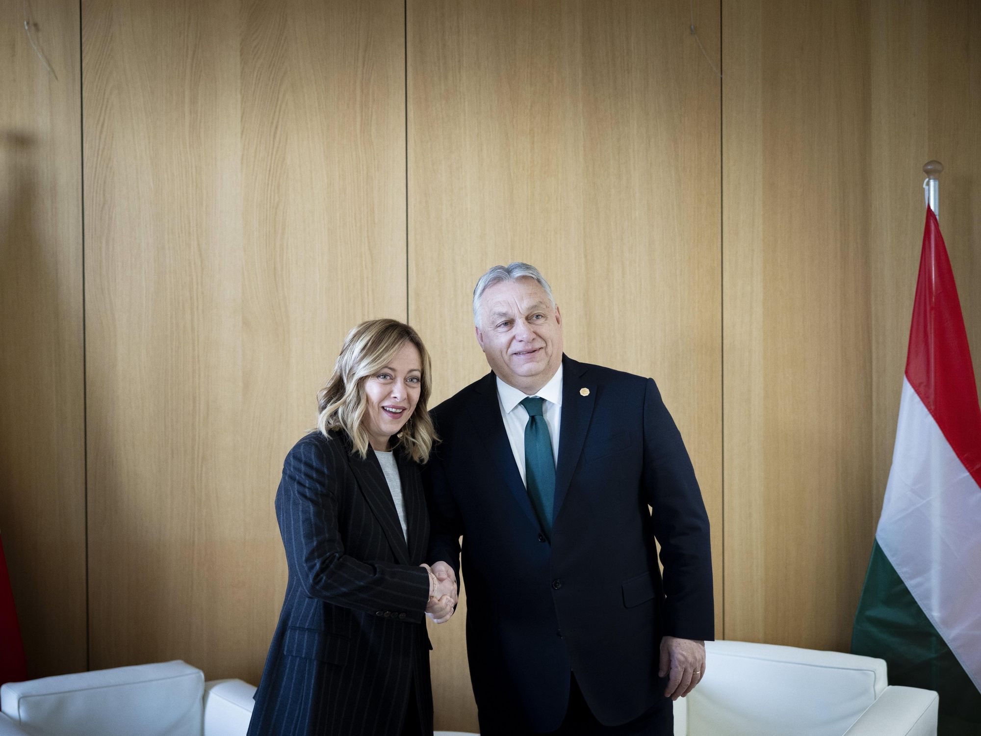 ​Italian Prime Minister Giorgia Meloni and Hungarian Prime Minister Viktor Orban shaking hands.