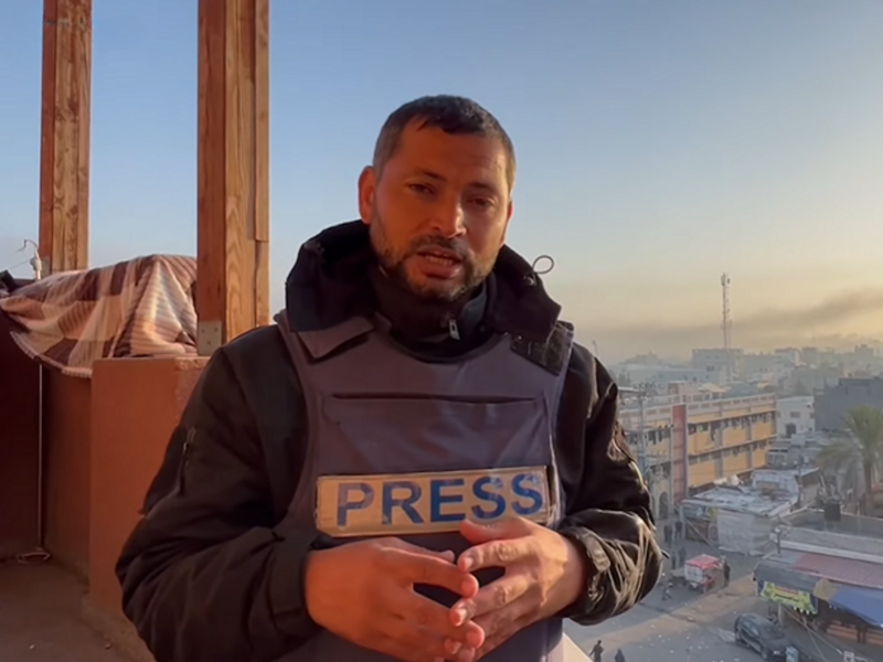 ​Journalist Abu Omar wearing a press vest.