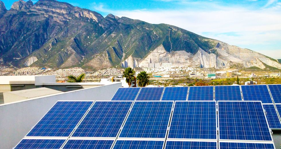 ​Lines of solar panels capturing green energy.