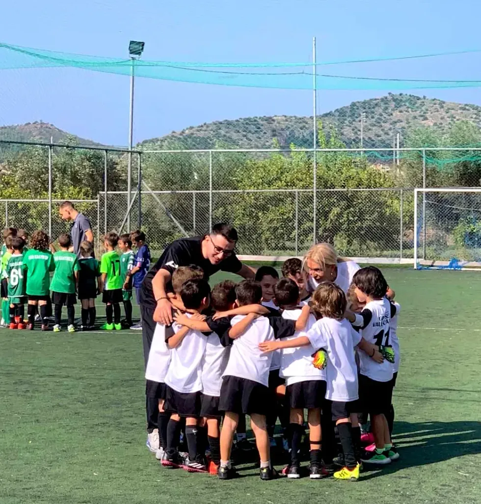 ​Lorenzo surronded by his teammates in a group huddle.