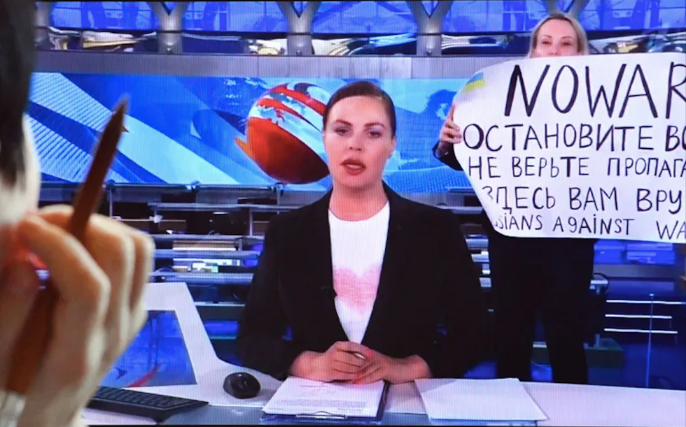 ​Marina Ovsiannikova protesting Russian invasion of Ukraine on state TV on March 14