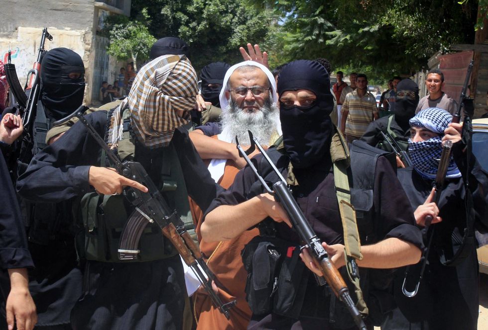 ​Members of Jund Ansar Allah surround their leader Abdel-Latif Moussa.