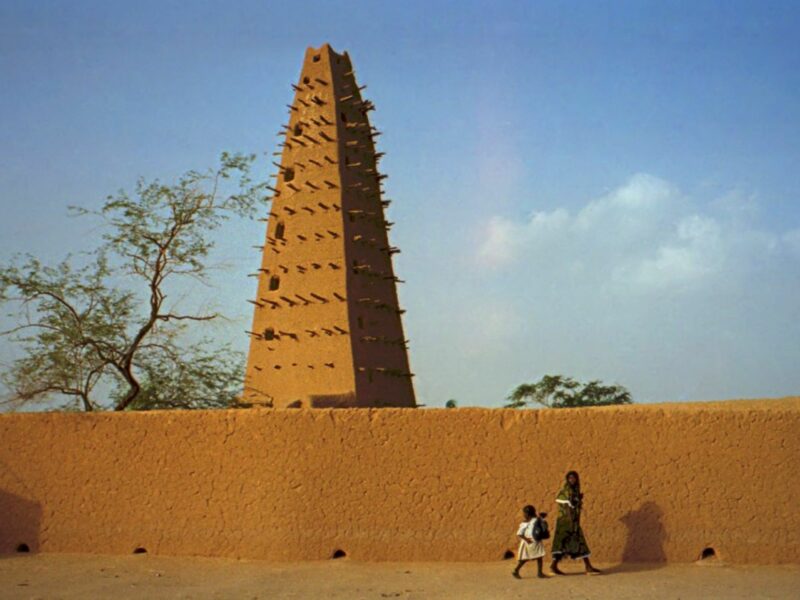 ​Mosque in Agadez, Niger, with two passersby