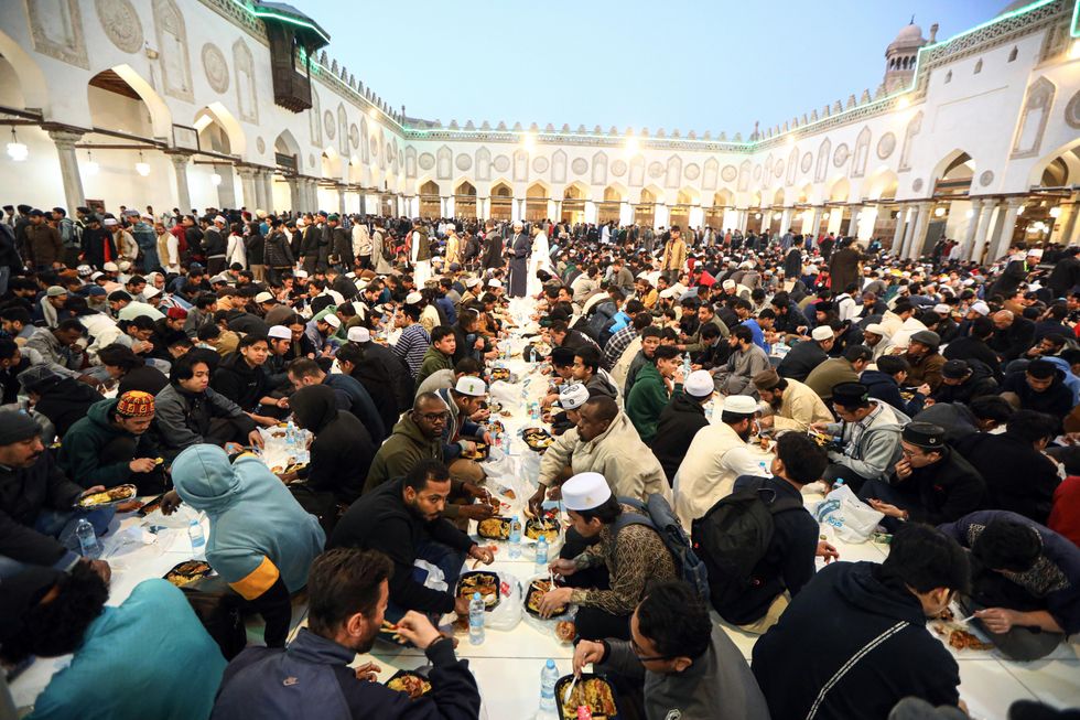​Muslims have iftar meals during Ramadan at Al-Azhar Mosque in Cairo, Egypt.