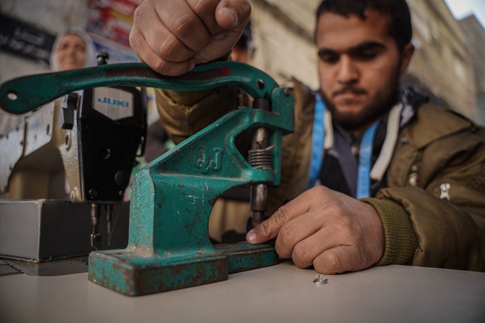 ​Nasim Muhammad ses a bicycle-powered sewing machine.