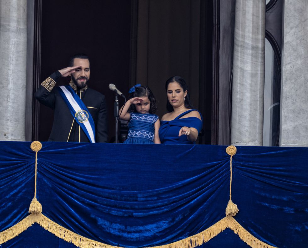​Nayib Bukele, re-elected President of El Salvador, his daughter Layla Bukele and First Lady Gabriela de Bukele greet the military during a parade in front of the National Palace in the capital.