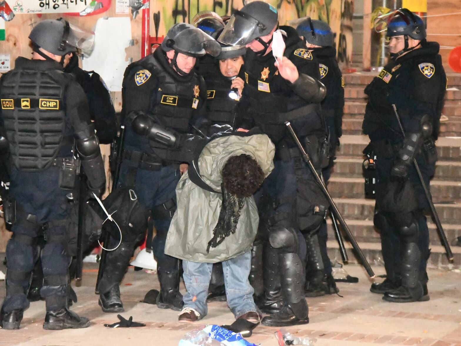 ​One of many arrests made by CHP officers in riot gear to take down a pro-Palestinian encampment on the UCLA campus.