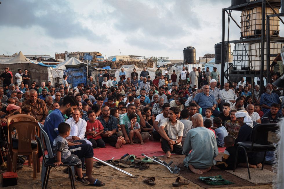 ​Palestinains gather to hold Eid al-Adha prayers inside the camp.