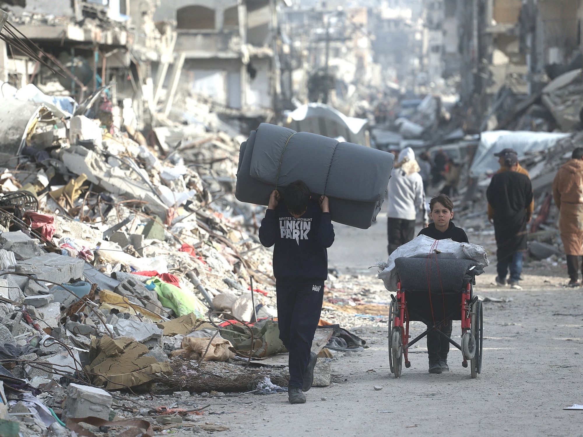 ​Palestinians amidst the massive destruction of homes and infrastructure in the Jabalia camp.