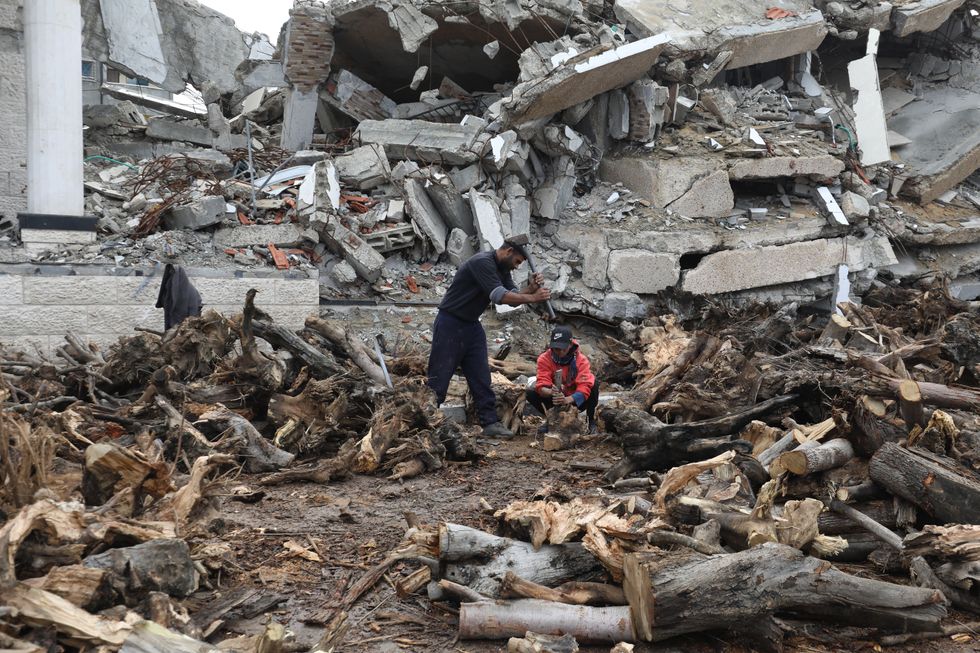 ​Palestinians chopping wood amid shortage of gas cylinders and fuel at the Al-Bureij Refugee Camp.