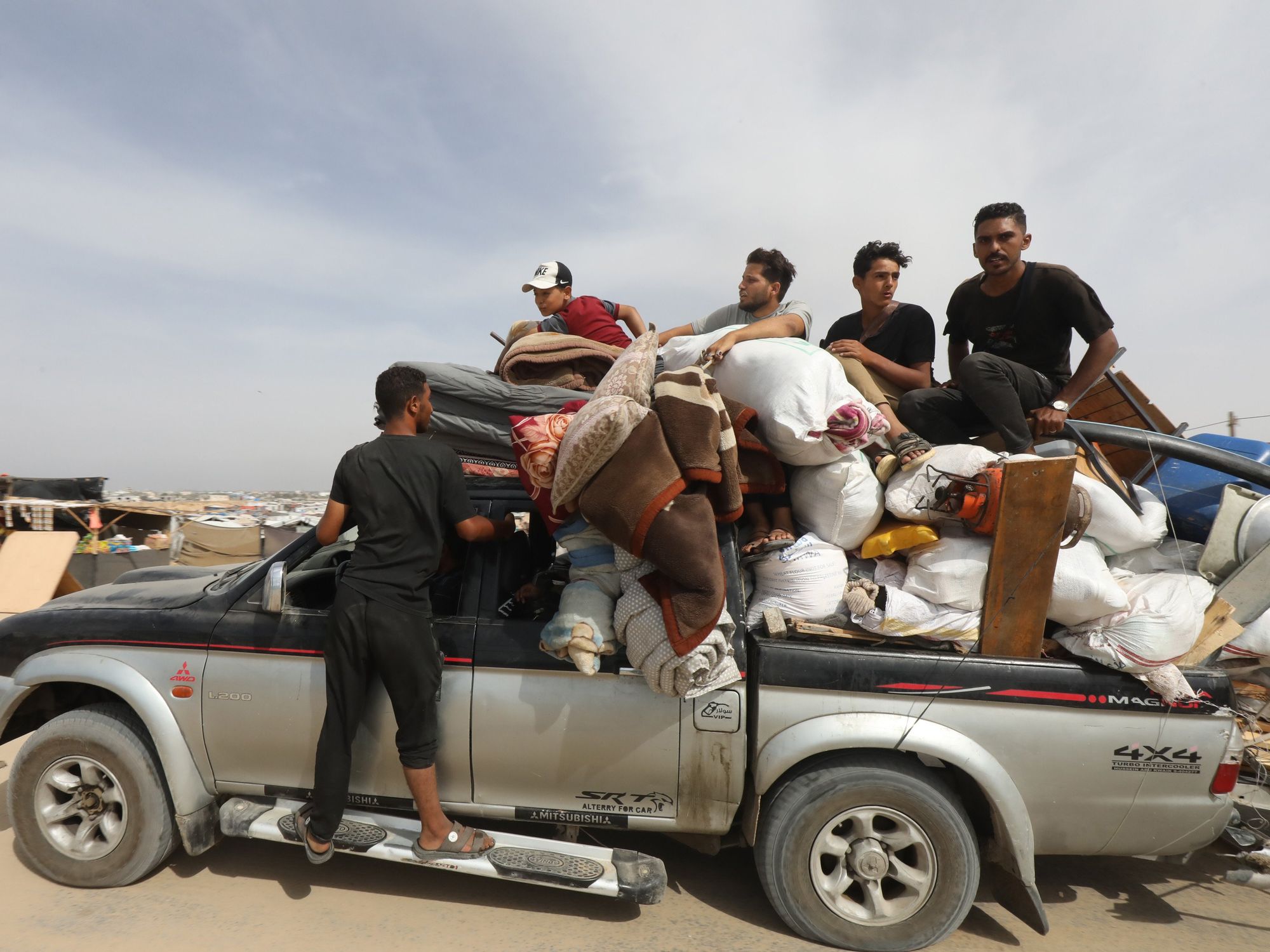 ​Palestinians fleeing unsafe areas in Rafah arrive with their belongings on Trucks and cars in Khan Yunis, further north in the southern Gaza Strip.