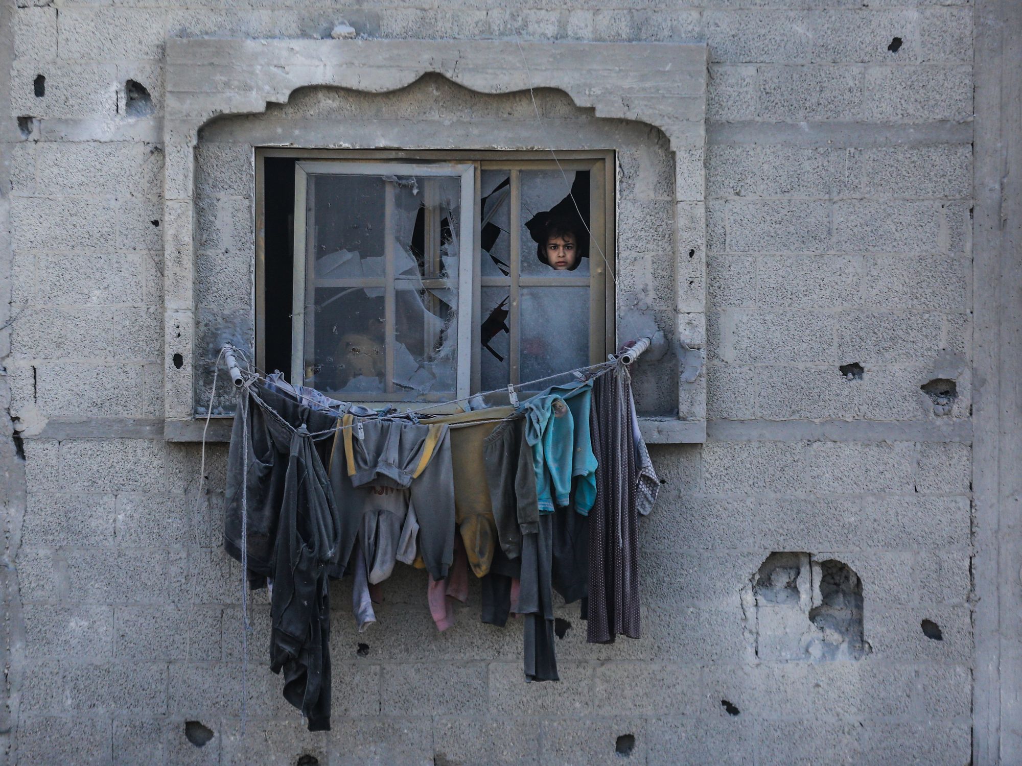 ​Palestinians inspect the damages of their home, which was bombed by Israeli army aircraft at dawn today in the city of Rafah