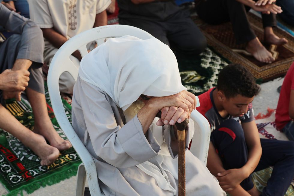 ​Palestinians perform Eid al-Adha prayer among the rubble of Al-Yaqeen Mosque which was destroyed in the Israeli attack, in Khan Younis, Gaza Strip.
