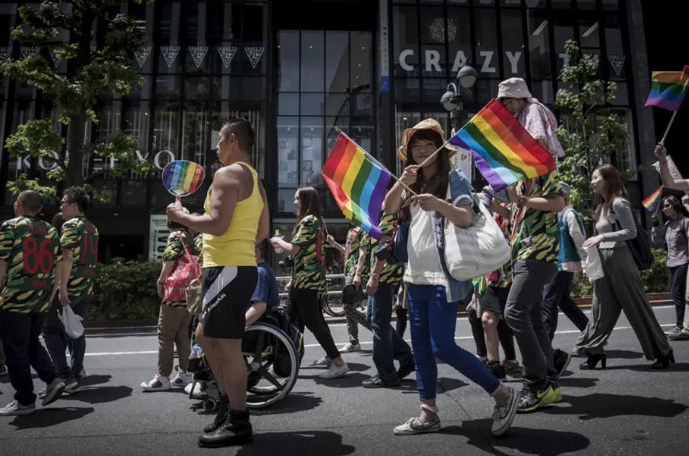 ​Participants hold a banner as they march during the 2016 Tokyo Rainbow Pride parade