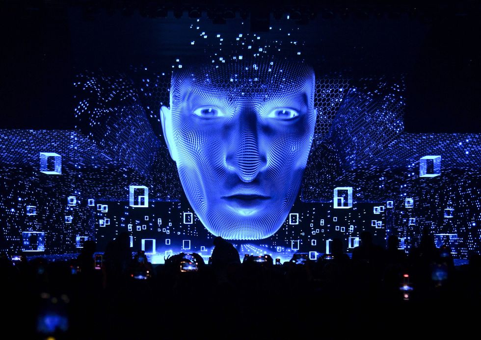 ​People look at display screens during opening of the ConteQ Expo24 Advanced Technology for Construction & Services Expo at the Qatar National Convention Centre QNCC, Sept. 16, 2024.