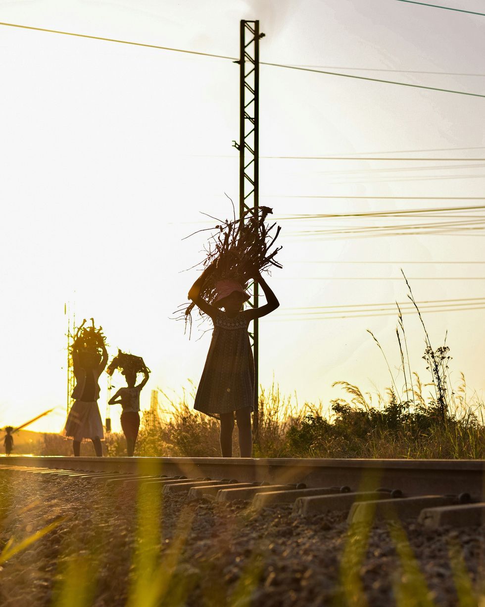 ​People walking along a train track in Zimbabwe.