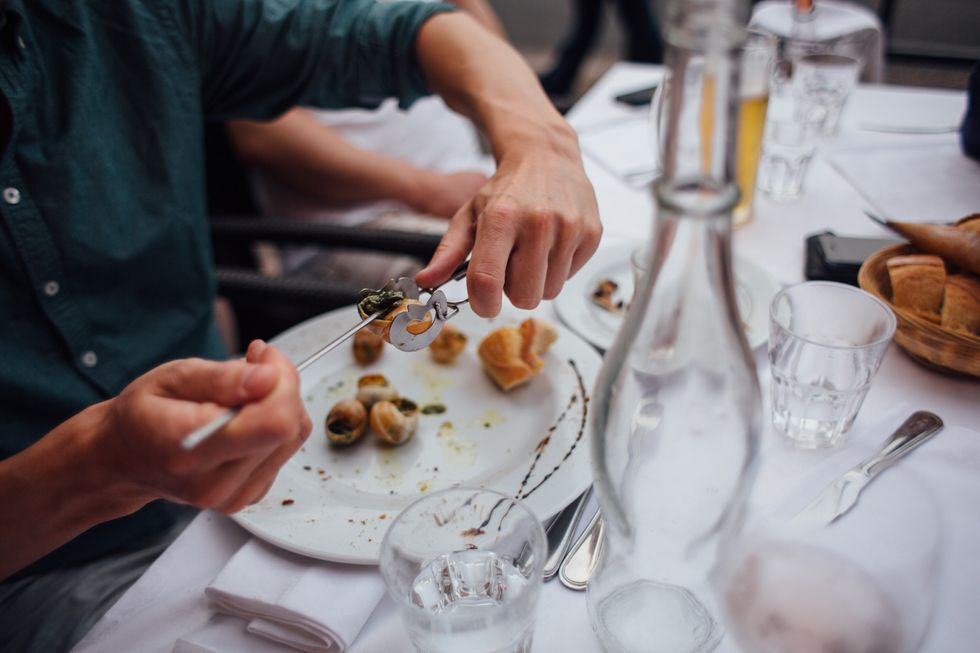​Person eating snails