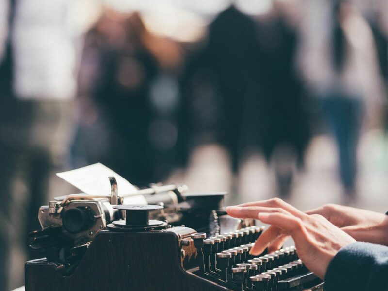 ​Person using a old typewrtier.