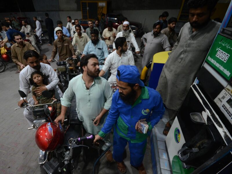 ​Photo of motorists wait to fill their vehicles' tanks at a petrol station