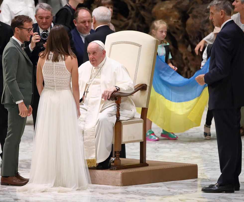​Pope Francis in front of a Ukrainian flag on Vatican City