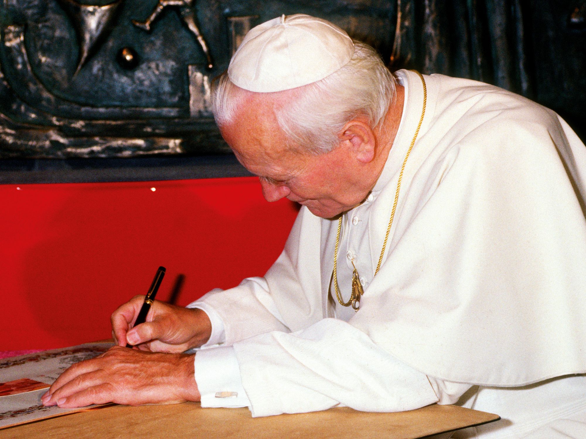 ​Pope John Paul II leaving his signature after he visited the parish of SS.