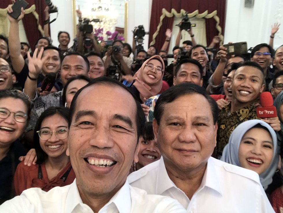 ​President Joko Widodo taking a selfie with ​Prabowo Subianto.