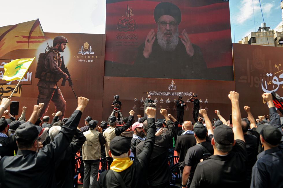 ​Pro-Iranian Hezbollah chief Hassan Nasrallah salutes his supporters prior the start of his televised speech in Beirut southern suburb during a mass rally.