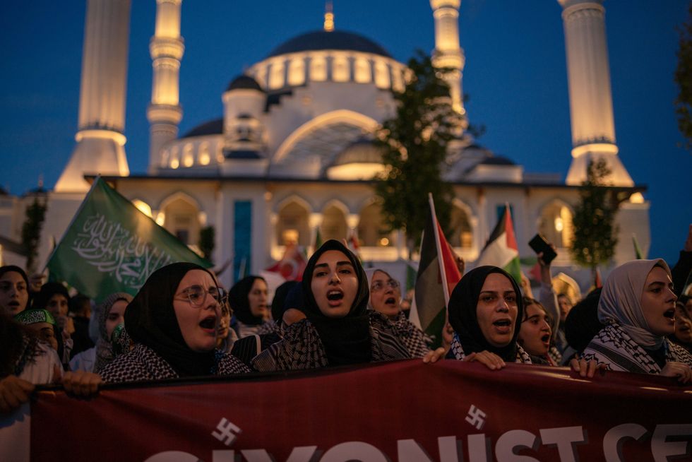 ​Protestors shout slogans during a protest solidarity with the Rafah people march from Barbaros Hayrettin Pasa Mosque to in front of the Israeli Consulate in Istanbul.