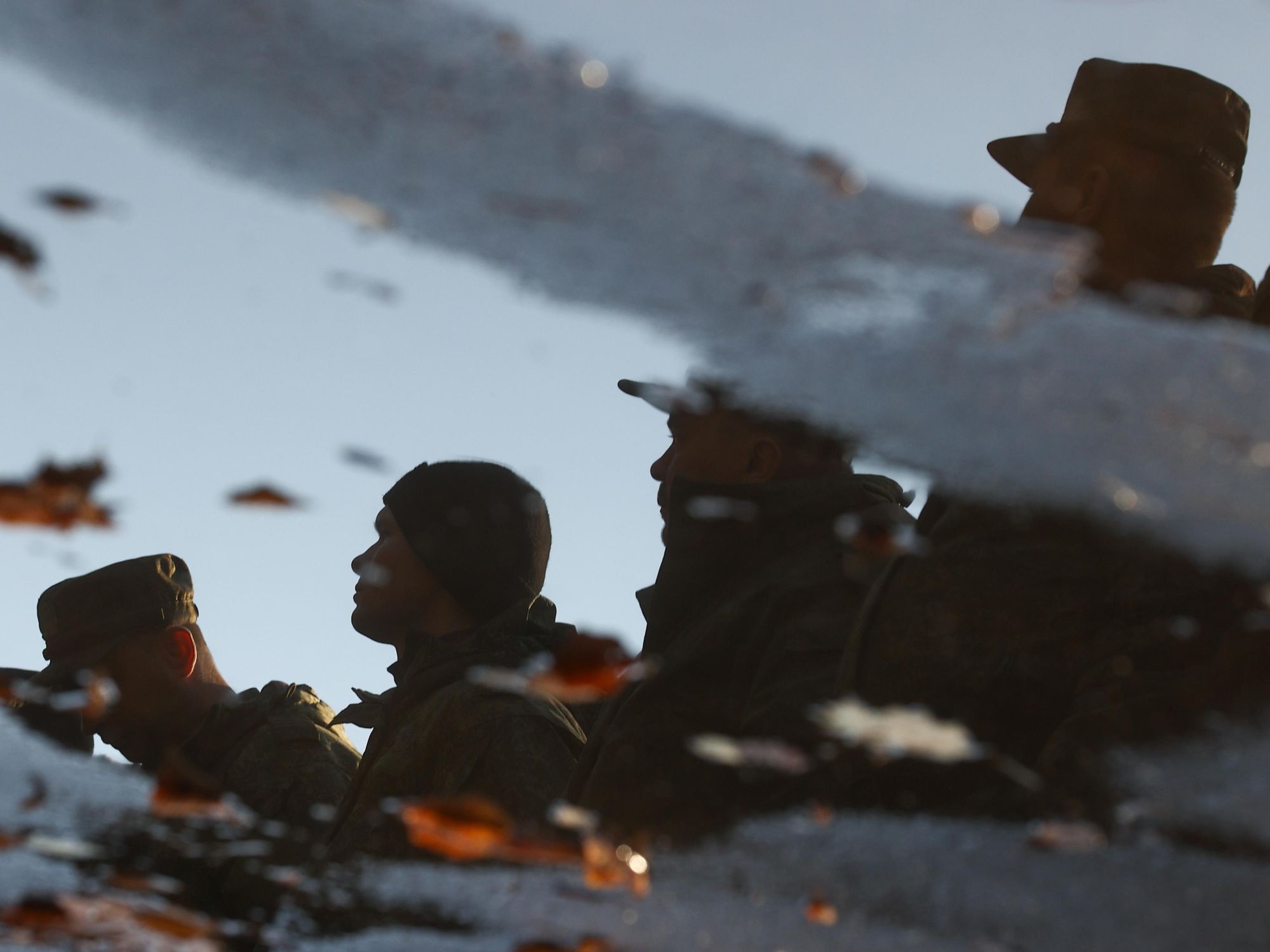 ​Reflection of Russian reservists in a puddle in Serpukhov, Russia