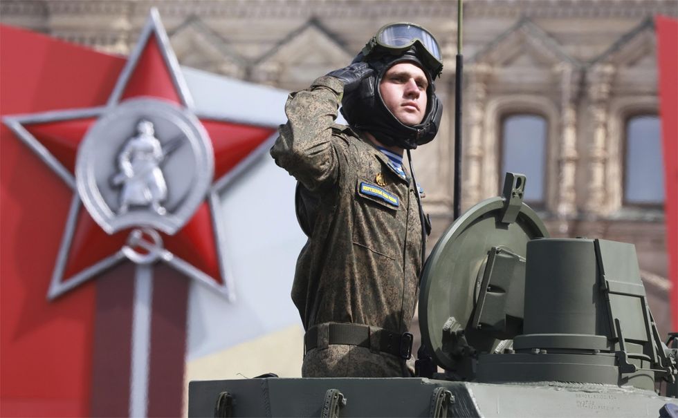 ​Russian soldier salutes as he passes the review stand during Victory Day military parade at Red Square
