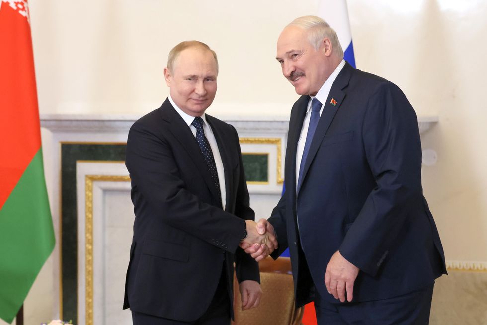 ​Russia's President Vladimir Putin and Belarusian President Alexander Lukashenko shaking hands