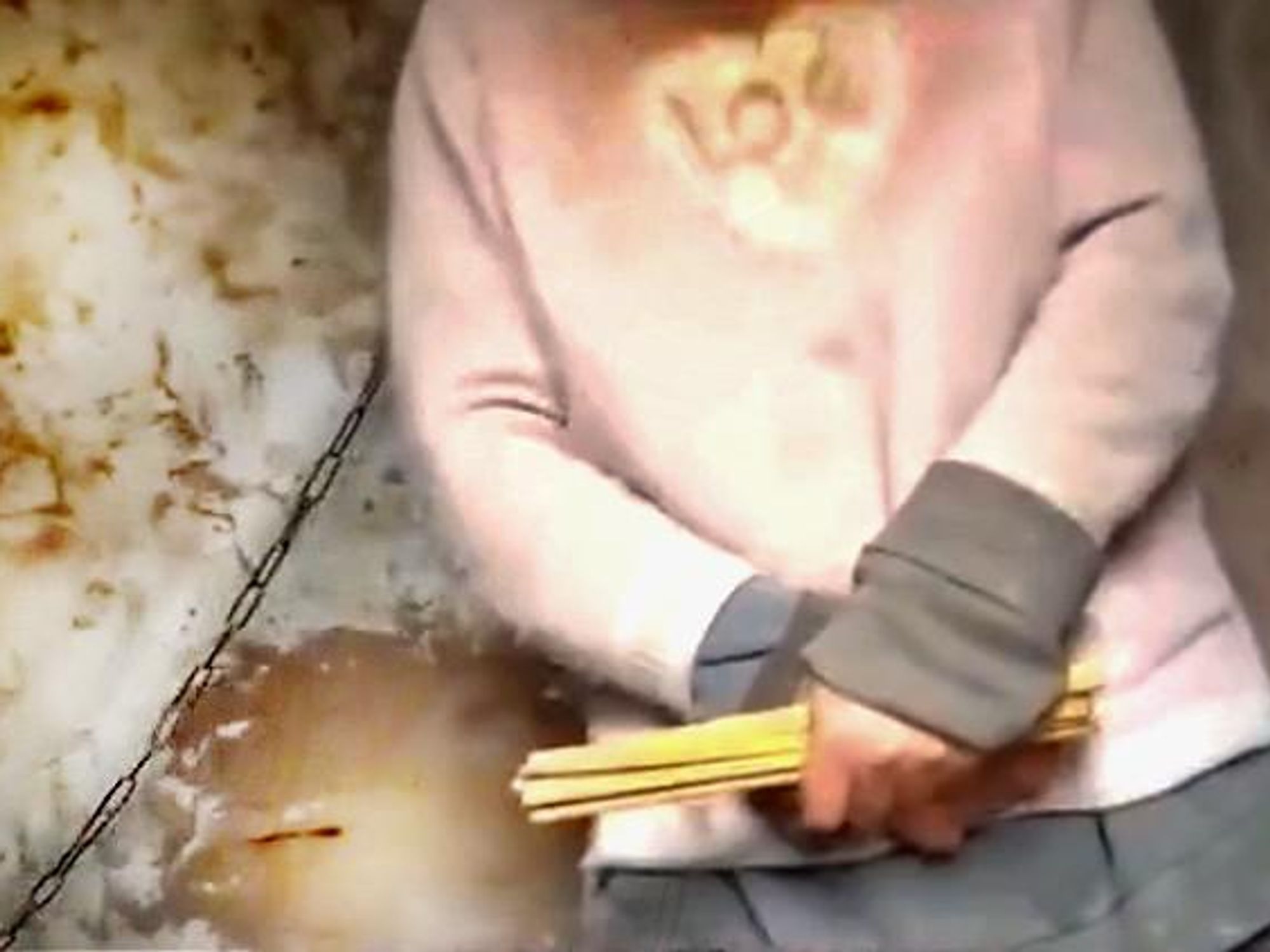​Screenshot from video of chained mother-of-eight in China