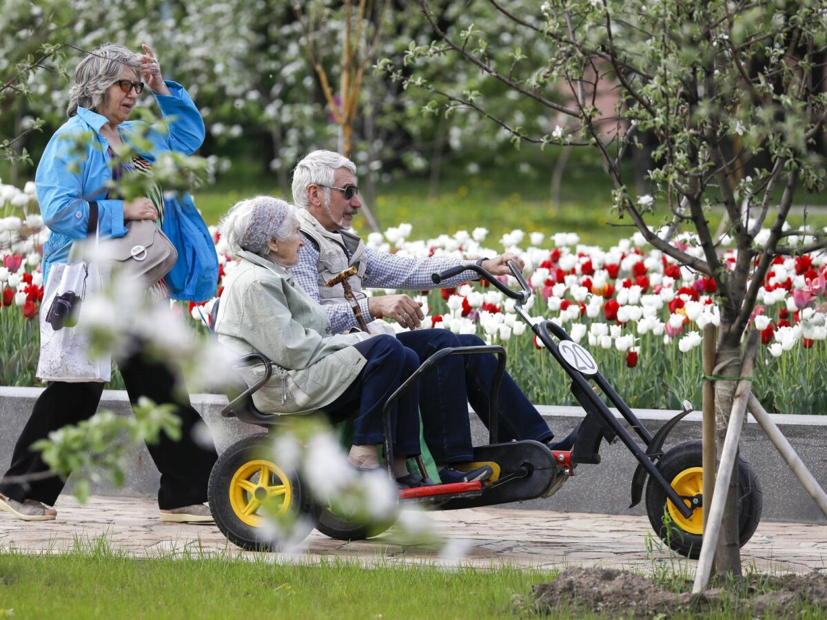 ​Senior citizens riding a tricycle at the VDNKh exhibition centre and park in Moscow, Russia, May 11, 2019.