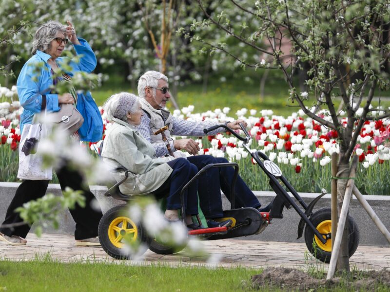 ​Senior citizens riding a tricycle at the VDNKh exhibition centre and park in Moscow, Russia, May 11, 2019.