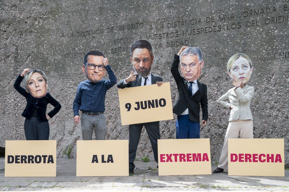 ​Several activists wearing the faces of different far-right politicians.