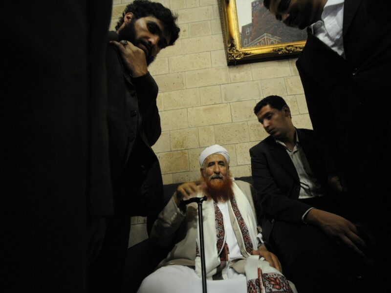 ​Sheik Abdul Majeed Al Zindani sits surrounded by bodyguards in the Sana'a airport.