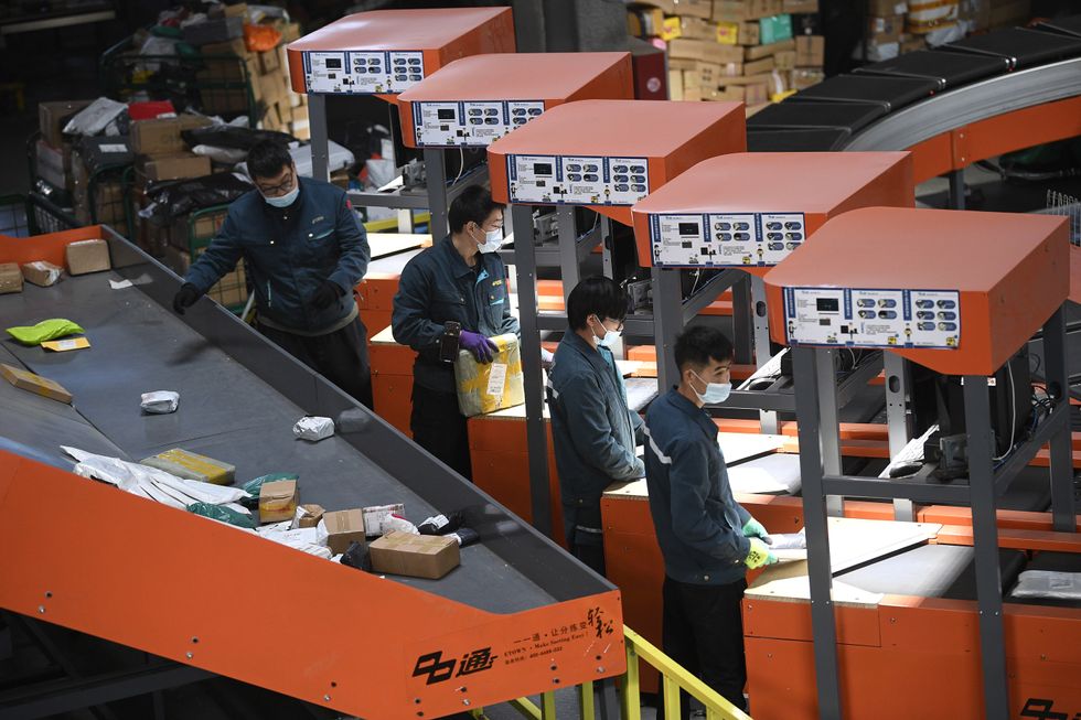​Staff members sort packages at a logistics center in Yinchuan, northwestern China.