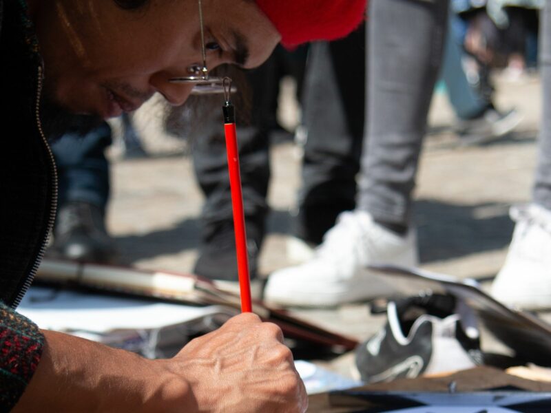 ​Street artist painting on paper