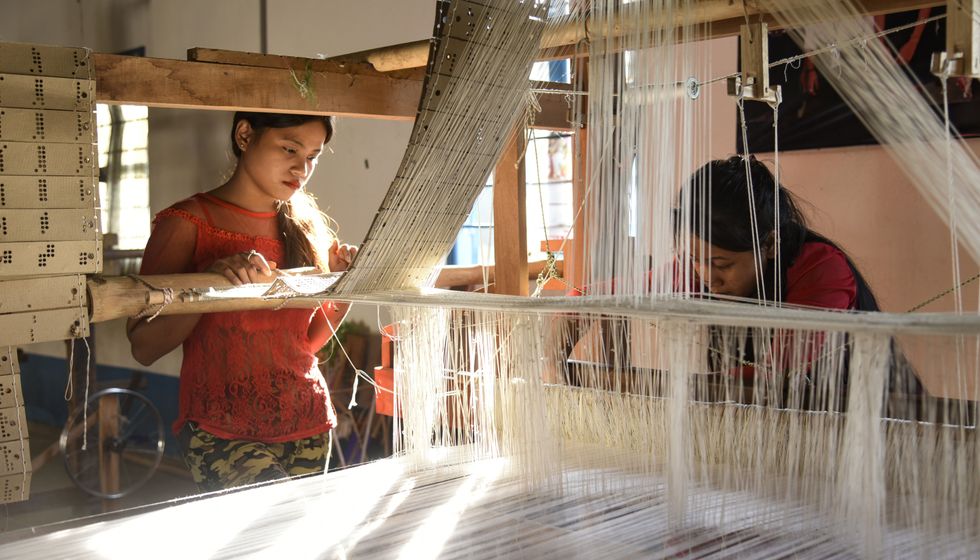 ​Students weaving silk in the Parijat Academy, a non-profit school for underprivileged children in Guwahati, India, in 2020.