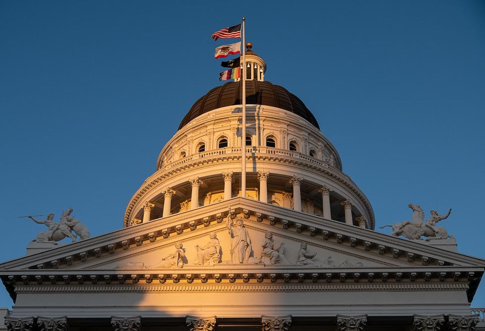 ​The LGBTQ+ flag flies over the State Capitol in Sacramento