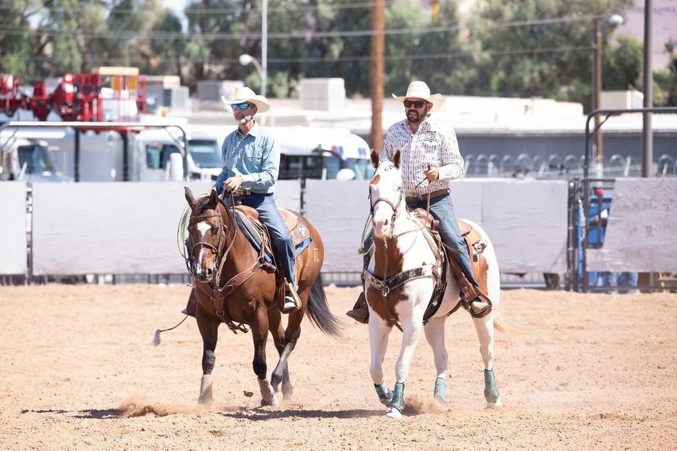 ​Two cowboys riding hores at the Big Horn Rodeo.