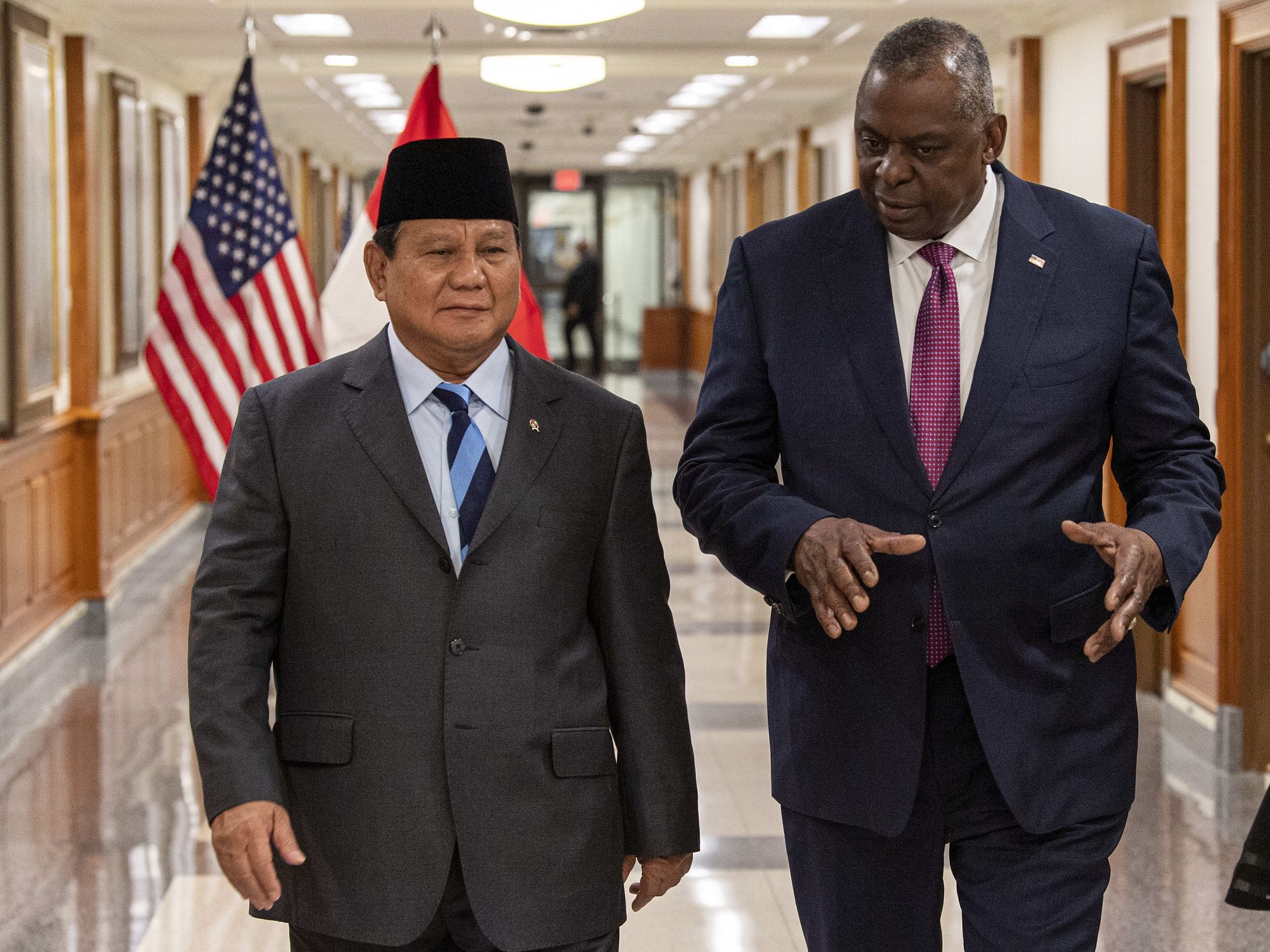 ​U.S. Secretary of Defense Lloyd J. Austin III, right, escorts Indonesian Defense Minister Prabowo Subianto, left.