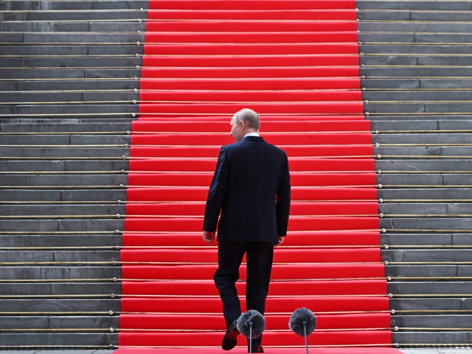 ​Vladimir Putin walks up stairs following an address.