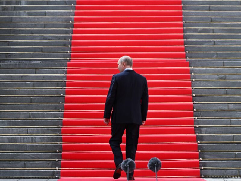 ​Vladimir Putin walks up stairs following an address.